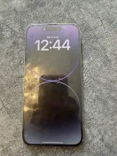 The listing photo: a midnight purple iPhone 14 Pro Max on a grey blanket, lockscreen on, scratches visible across the glass