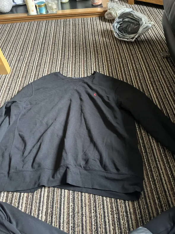 The original phone photo of a navy jumper